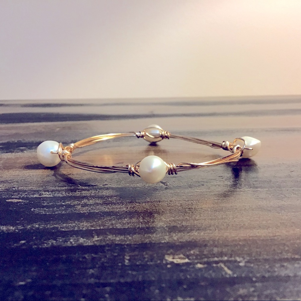 A bracelet it is gold and white it is for adults